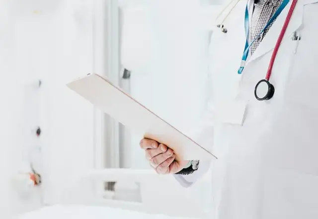 Doctor with stethoscope holding patient list, symbolizing guidance and oversight