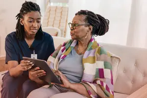 Nurse helping patient sign in